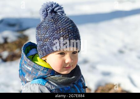 little boy walking in winter park Stock Photo