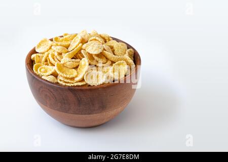 corn flake in bowl and empty space for text isolated on white background, plate of cornflakes, healthy breakfast concept, side view Stock Photo