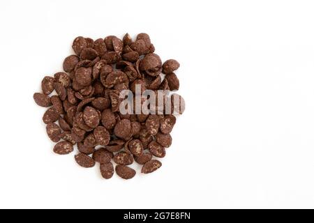 chocolate flakes isolated on white background, healthy dry breakfast concept, heap of cereal corn flakes, top view Stock Photo