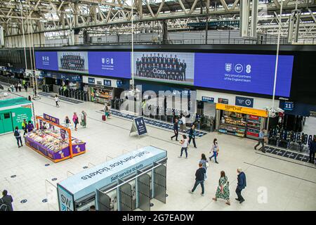 WATERLOO LONDON  13 July 2021.  The England national football team is displayed on a digital  board above the concourse at Waterloo station. The England national football team lost on penalties to Italy at the Uefa Euro 2020 final at Wembley. Several England players Marcus Rashford, Jadon Sancho & Bukayo Saka have received racial abuse on social media  after missing penalties during the final. Credit amer ghazzal/Alamy Live News Stock Photo