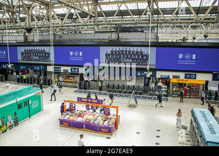 WATERLOO LONDON  13 July 2021.  The England national football team is displayed on a digital  board above the concourse at Waterloo station. The England national football team lost on penalties to Italy at the Uefa Euro 2020 final at Wembley. Several England players Marcus Rashford, Jadon Sancho & Bukayo Saka have received racial abuse on social media  after missing penalties during the final. Credit amer ghazzal/Alamy Live News Stock Photo