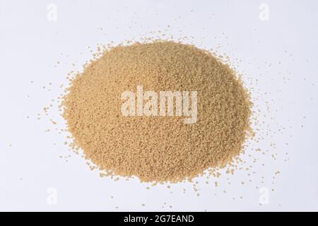 pile of wholemeal cous-cous on white background Stock Photo