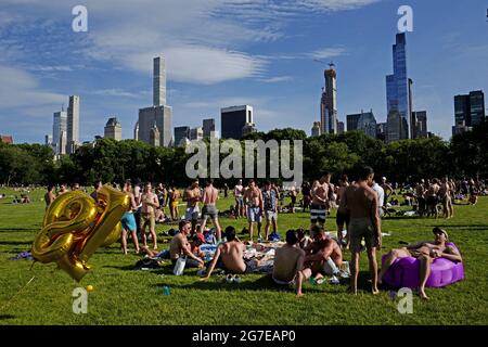 Swimsuit guys gathering at Central Park on an hot summer saturday afternoon, in New York City. Stock Photo