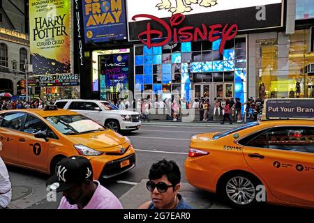 Disney store and yellow cabs at Times Square in Manhattan, in New York City. Stock Photo