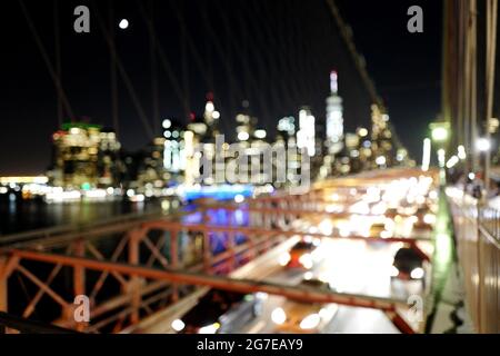 Blutty night view of the Manhattan skyline from the Brooklyn bridge, in New York City. Stock Photo