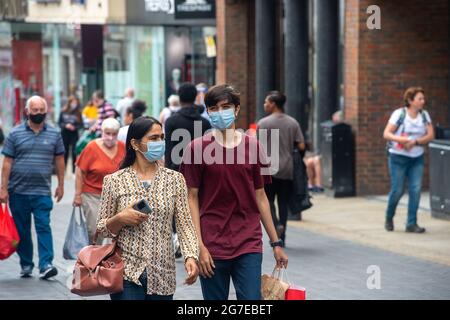 Windsor, Berkshire, UK. 13th July, 2021. Shoppers were out in Peascod Street in Windsor today. Some people are continuing to wear face masks as they walk around the town. The number of positive Covid-19 cases in the Royal Borough of Windsor and Maidenhead for the week up to 8th July per 100,00 people is currently 206 up from 143. Credit: Maureen McLean/Alamy Live News Stock Photo