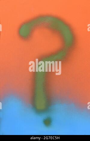 question mark painted on a blue spray paint and paper background Stock Photo