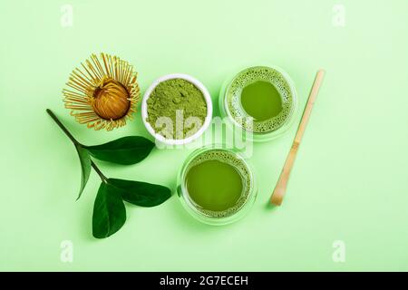 Green matcha tea drink and tea accessories on green background. Japanese tea ceremony concept. Copy space Stock Photo