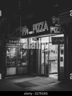 99 cent pizza shop at night, in the East Village, Manhattan, New York City Stock Photo