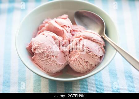 Strawberry ice creams scoops in blue bowl Stock Photo