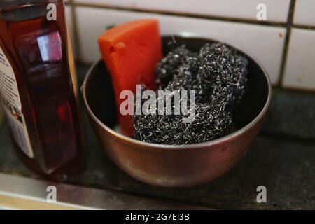 Closeup shot of soap and washing tools on the kitchen sink Stock Photo