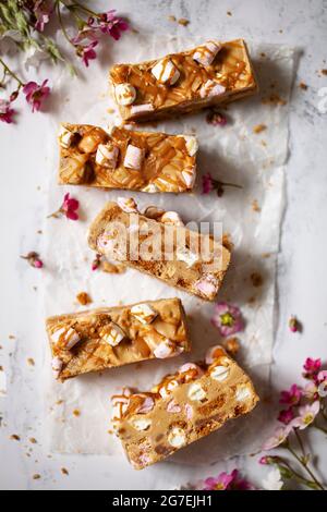 Five slices of white chocolate rocky road on wax paper Stock Photo