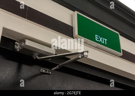 Exit sign on the door. Close up Exit sign on door in the building. Evacuation exit. Stock Photo