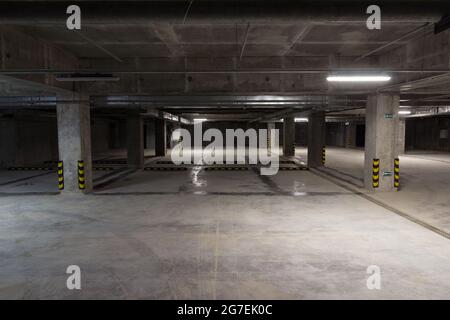 Empty underground parking. Free parking spaces. Alternative parking. Parking for cars within the city Stock Photo