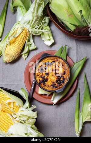 Latin American Chilean baked copn pie Pastel de Choklo in autentical clay bowls. Top view Stock Photo