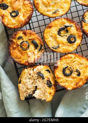 Savory meat muffins on cooling tray. Homemade delicious muffins with chicken, zucchini, olives, eggs without flour and cheese. Paleo diet and lunch to Stock Photo