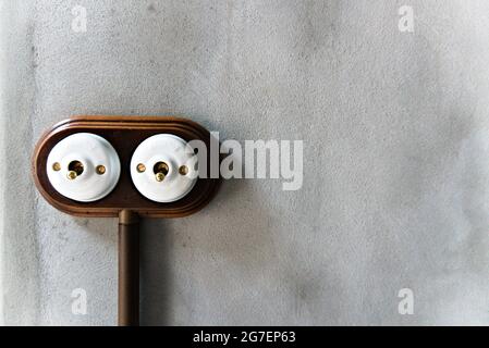 Two vintage light switches on a concrete wall Stock Photo