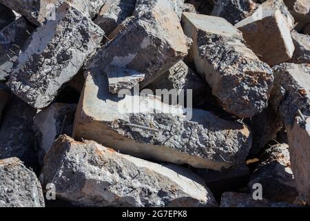 Broken concrete pillars. Fragments of used broken concrete. Construction material Stock Photo