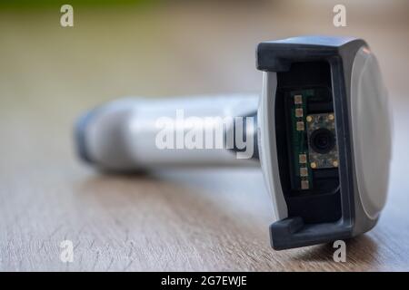 Close-up of a handheld scanner on a wooden table Stock Photo