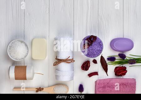 Flat lay items for spa treatment on white wooden desk. Stock Photo
