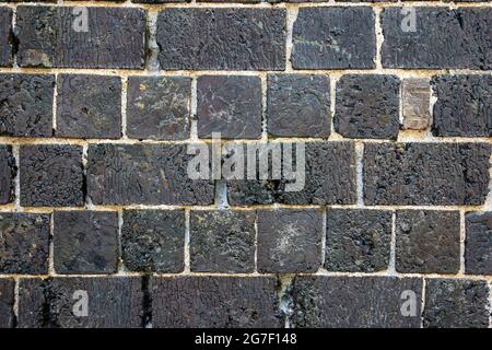Black slag brick wall in Fiskars village of Raasepori, Finland Stock Photo