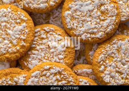 Pile of Frosted Oatmeal Cookies Background Texture. Stock Photo