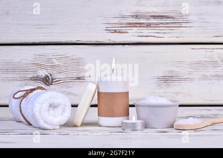 Spa concept. Terry towel with candle and salt. Stock Photo