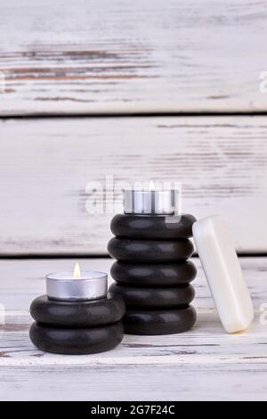 Stack of stones with candles and soap vertical shot. Stock Photo