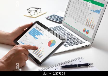 Analyst works with the data. Graphs on the screen Stock Photo