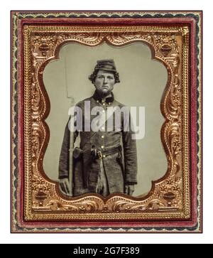 AMERICAN CIVIL WAR Soldier in Confederate uniform with frock coat and forage cap with cap box, bayoneted musket, and holstered revolver] [between 1861 and 1865] sixth-plate tintype, hand-colored ; Official portrait as a family keepsake before going to fight in the American Civil War Stock Photo