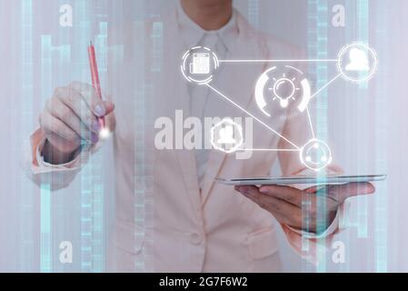 Lady In Uniform Touching Different Application In Projected Hologram. Business Woman In Suit Holding Phone Displaying And Using Futuristic Holographic Stock Photo