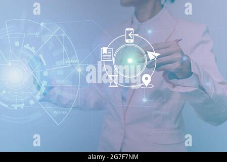 Woman In Uniform Standing Holding Tablet Showing Futuristic Virtual Interface. Lady In Suit Using Pencil Mobile Device Interacting With Holographic Stock Photo