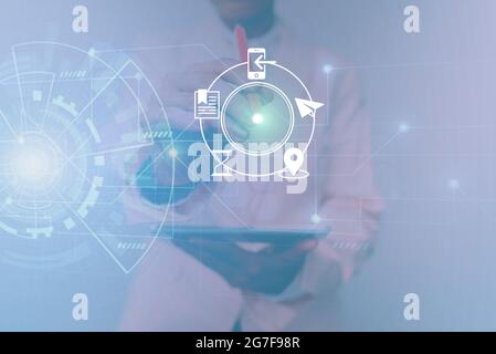 Woman In Uniform Standing Holding Tablet Showing Futuristic Virtual Interface. Lady In Suit Using Pencil Mobile Device Interacting With Holographic Stock Photo