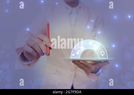 Lady In Uniform Holding Pen Phone With Futuristic Virtual Interface. Business Woman Using Pencil And Mobile Device Interacting With Holographic Stock Photo