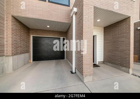 Townhouse garage exterior with smooth brown bricks Stock Photo