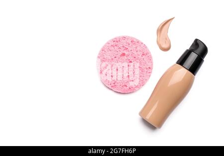 Makeup sponge and foundation with sample on white background Stock Photo