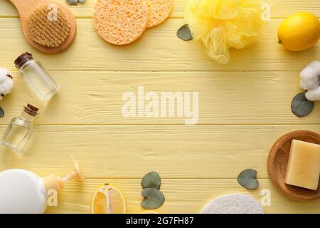 Frame made of bath supplies on color wooden background Stock Photo