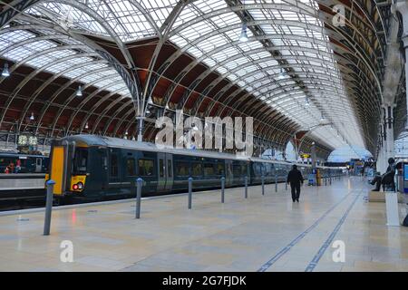 Early morning at Paddington overground station with train seen on the platform and a solitary worker. Stock Photo