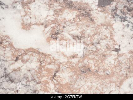 Pale brown marble with white splashes, close-up of polished natural stone surface. Background, pattern, texture. Stock Photo