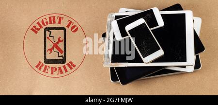 right to repair symbol next to broken tablets and smart phones on board consumer right to repair goods Stock Photo