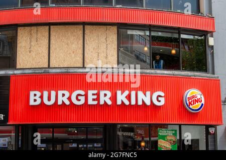 London, UK. 13th July, 2021. Windows on the Burger King restaurant in London's Leicester Square seen boarded up after England football fans threw bottles at them before the Euro 2020 final on Sunday. (Photo by Dave Rushen/SOPA Images/Sipa USA) Credit: Sipa USA/Alamy Live News Stock Photo