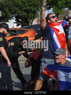 Orlando, United States. 12th July, 2021. Police attempt to move protesters out of the street as they demonstrate in Orlando in support of the Cuban people and against the Cuban government after thousands of Cubans took to the streets across the country to protest electric power outages, pandemic restrictions and the pace of Covid-19 vaccinations. Credit: SOPA Images Limited/Alamy Live News Stock Photo
