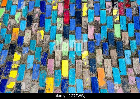 Top view on pieces of multicolored ceramic tiles decorated in garden. Old pavement of tiles textured. Street mosaic cobblestone sidewalk. Abstract,bac Stock Photo