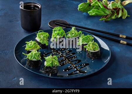 Makizushi rolls with wakame seaweed, asparagus, bell pepper, nut sauce Stock Photo