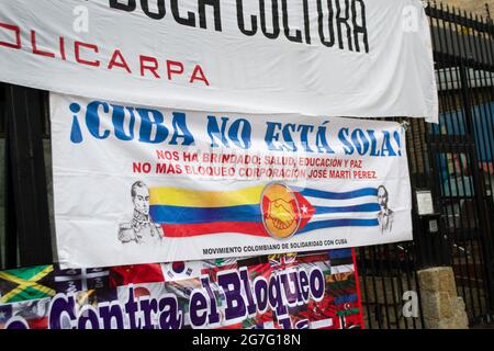 Bogota, Colombia on July 13, 2021, A sign with Colombia's flag and Cuba's flag along images of Simon Bolivar and Jose Marti that reads "Cuba is not alone" as Cuban residents residing in Colombia that protest against the president Miguel Diaz-Cannel protest in Bogota, Colombia on July 13, 2021 after anti-government protest raised in Cuba ended in unrest and violence last sunday July 13 after president Cannel urged supporters to confront protests. Stock Photo