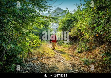 A tourist doing nature walk in Hampi, Karnataka, India Stock Photo