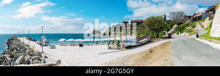 old town of nessebar, bulgaria. panorama of south beach with pier at high noon with clouds on the sky. popular travel destination Stock Photo