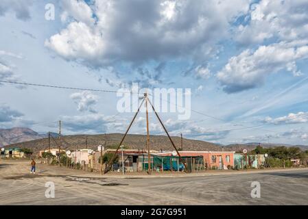 KLAARSTROOM, SOUTH AFRICA - APRIL 21, 2021: A street scene in Klaarstroom in the Western Cape Province. Houses, shacks and one person are visible Stock Photo