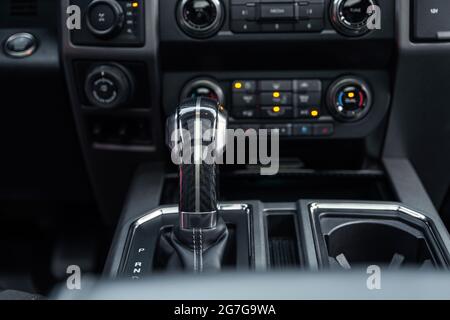 Luxury car interior. Control panel, radio system, shift lever. Automatic transmission gearshift stick. Selective focus. Stock Photo