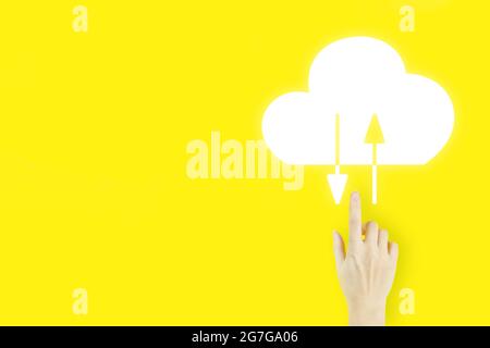 Abstract cloud connection technology background. Young woman's hand finger pointing with hologram Abstract cloud on yellow background. Cloud computing Stock Photo